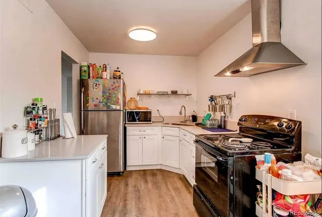 a kitchen with a sink stove and refrigerator