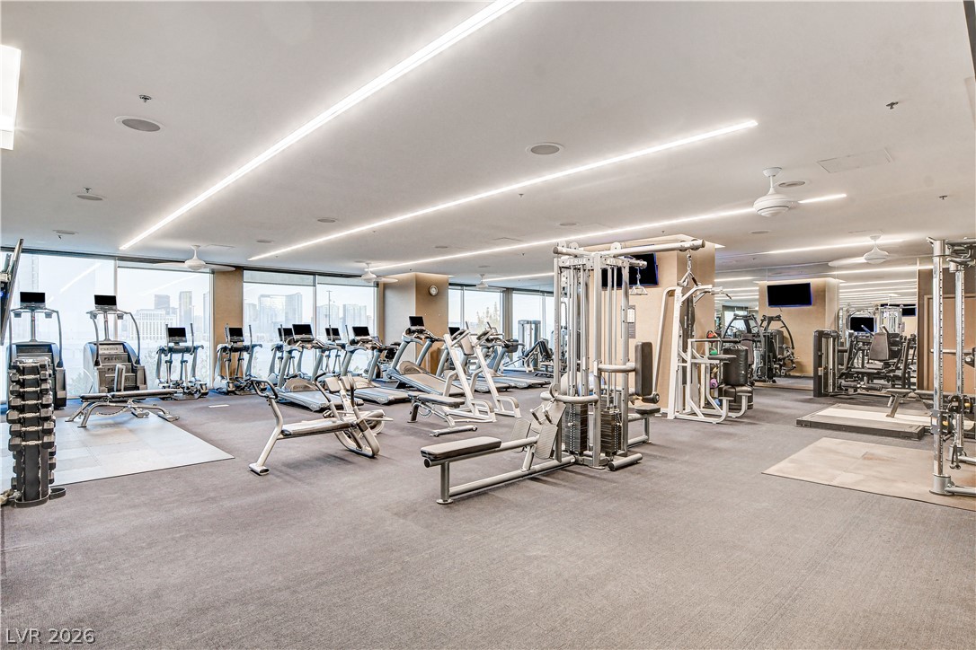 4381 West Flamingo Road, Unit 3002 Las Vegas, NV 89103 - Photo 30 of 59 Linear lighting and expansive wall-to-wall windows frame a spacious private fitness facility.