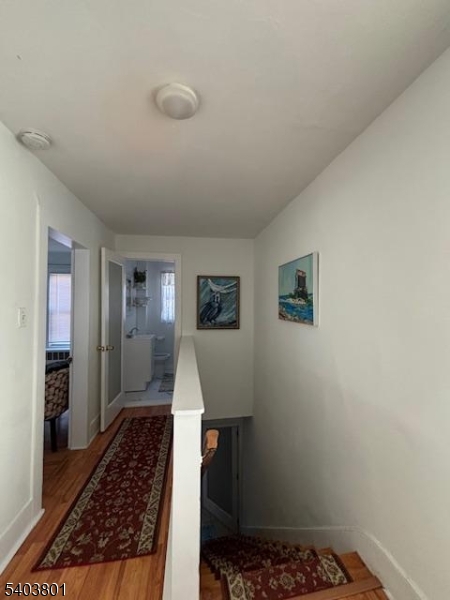 9 Madison Street Newton, NJ 07860 - Photo 13 of 13 a view of a hallway to a livingroom with wooden floor and a rug