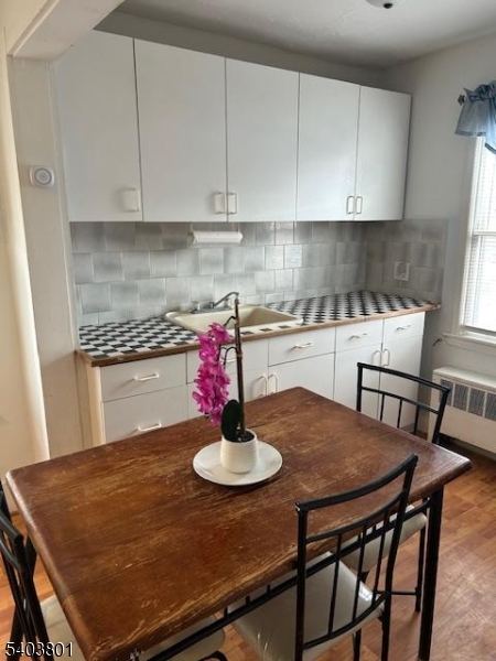 9 Madison Street Newton, NJ 07860 - Photo 3 of 13 a kitchen with a table chairs and a stove