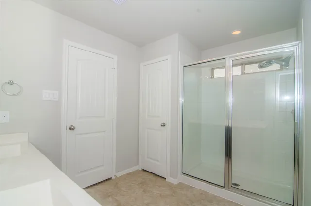 a bathroom with a shower and a sink