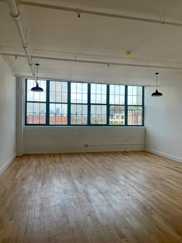 a view of wooden floor and windows in a room