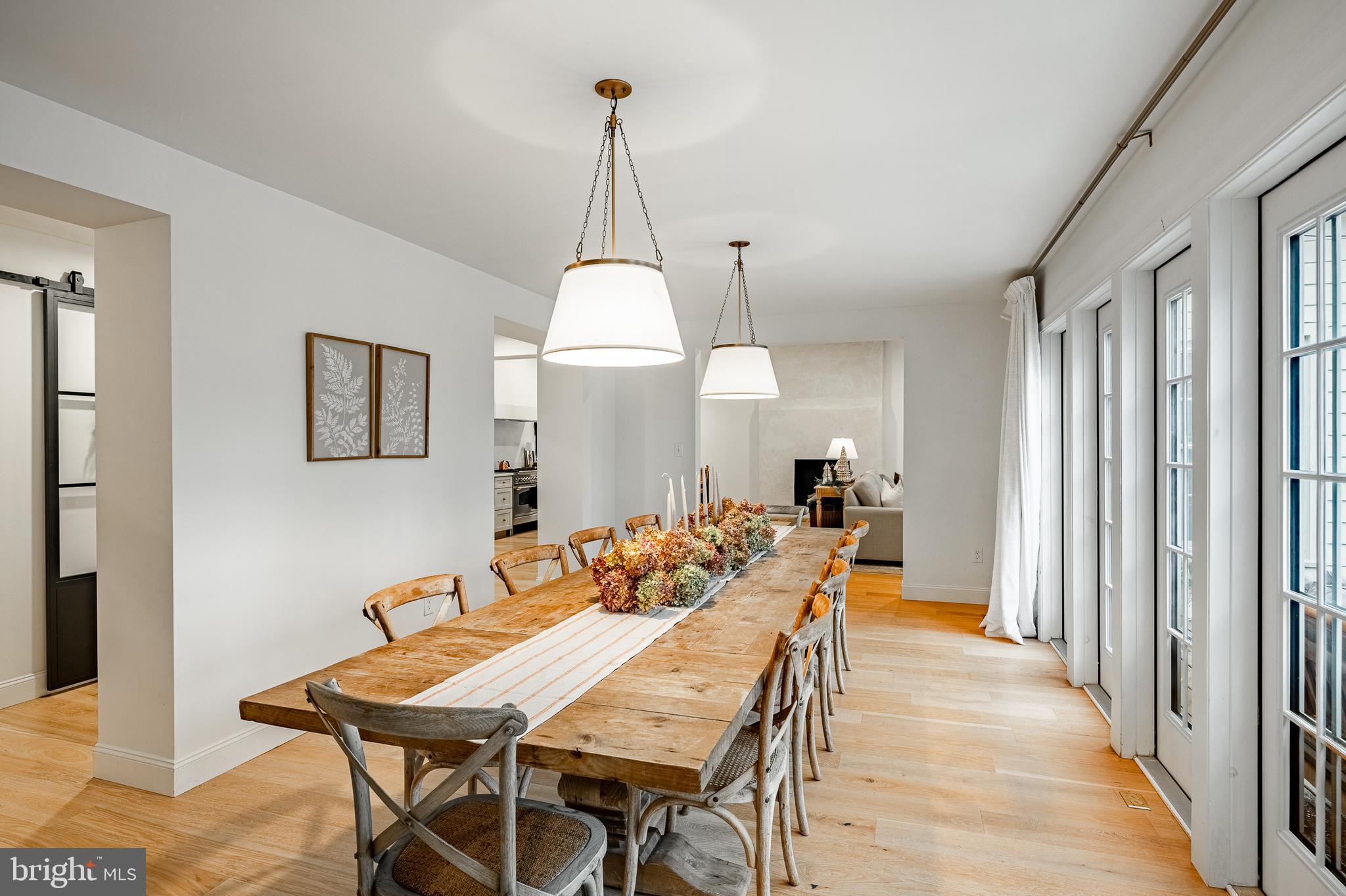 504 Kennett Pike Chadds Ford, PA 19317 - Photo 11 of 75 a view of a dining room and livingroom with furniture wooden floor a chandelier