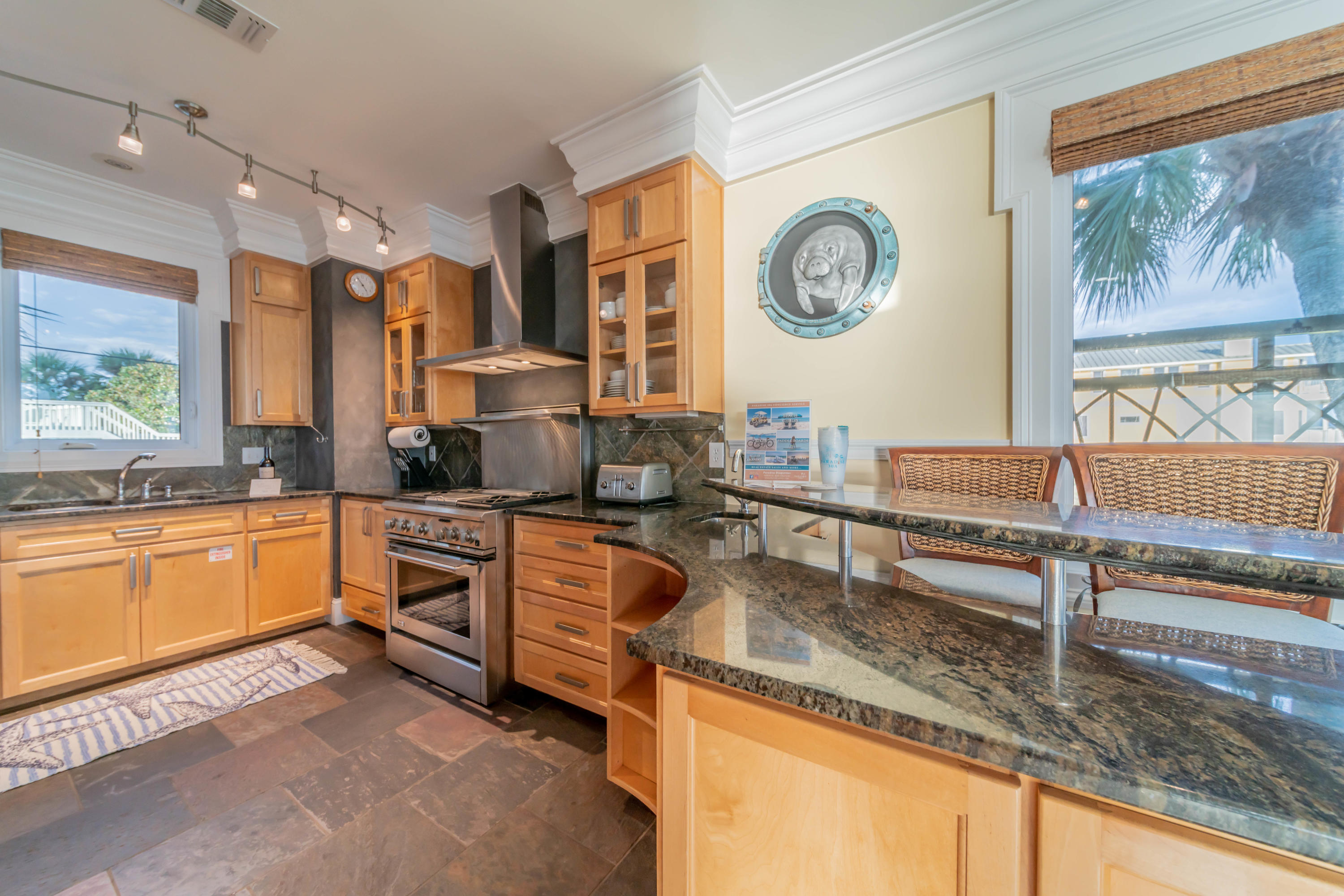 260 South Wall Street Inlet Beach, FL 32461 - Photo 48 of 59 a kitchen with stainless steel appliances granite countertop a stove and a sink