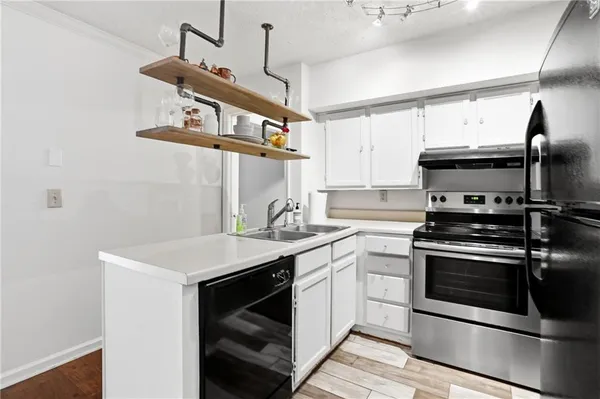 a kitchen with appliances cabinets and a sink