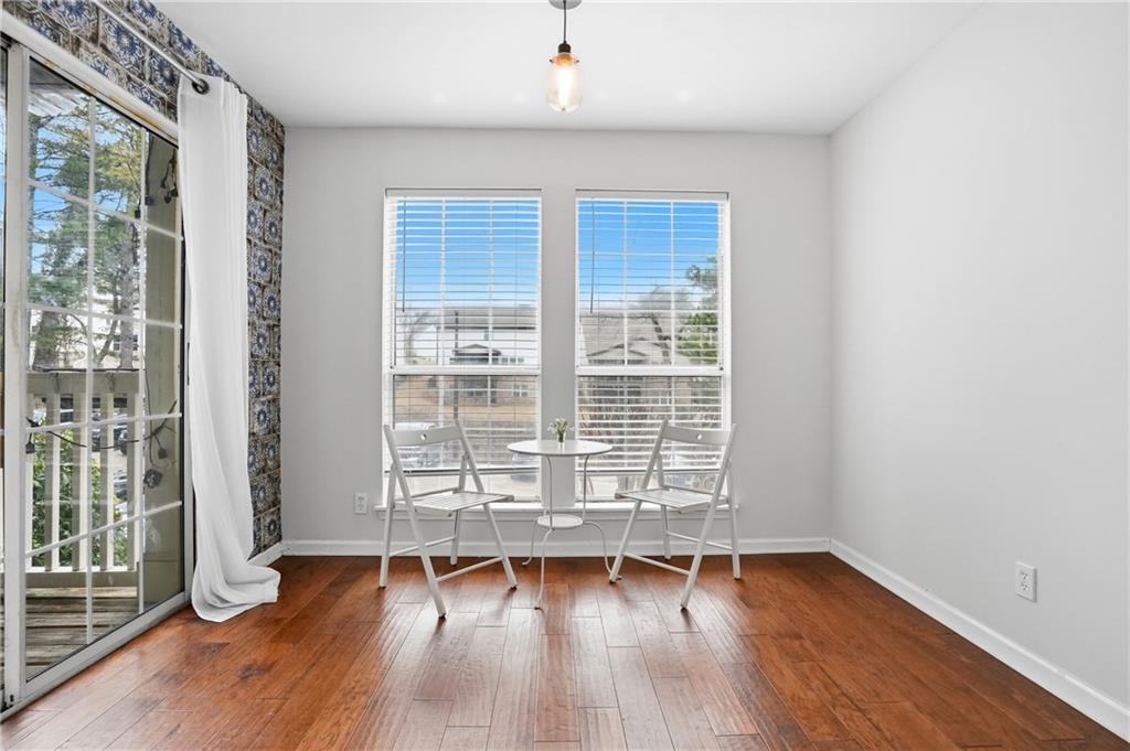 561 Cobblestone Trail Avondale Estates, GA 30002 - Photo 6 of 13 an empty room with wooden floor and windows