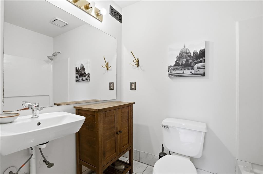 561 Cobblestone Trail Avondale Estates, GA 30002 - Photo 10 of 13 a bathroom with a toilet a sink and mirror
