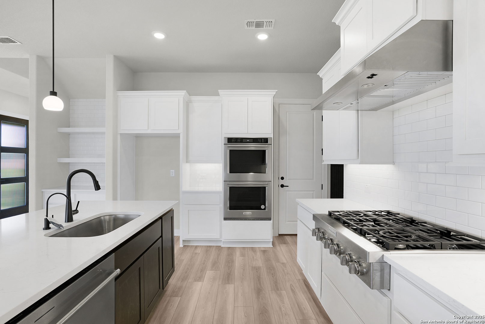 972 Nolte Bend Seguin, TX 78155 - Photo 23 of 65 a kitchen with kitchen island a sink stainless steel appliances and cabinets