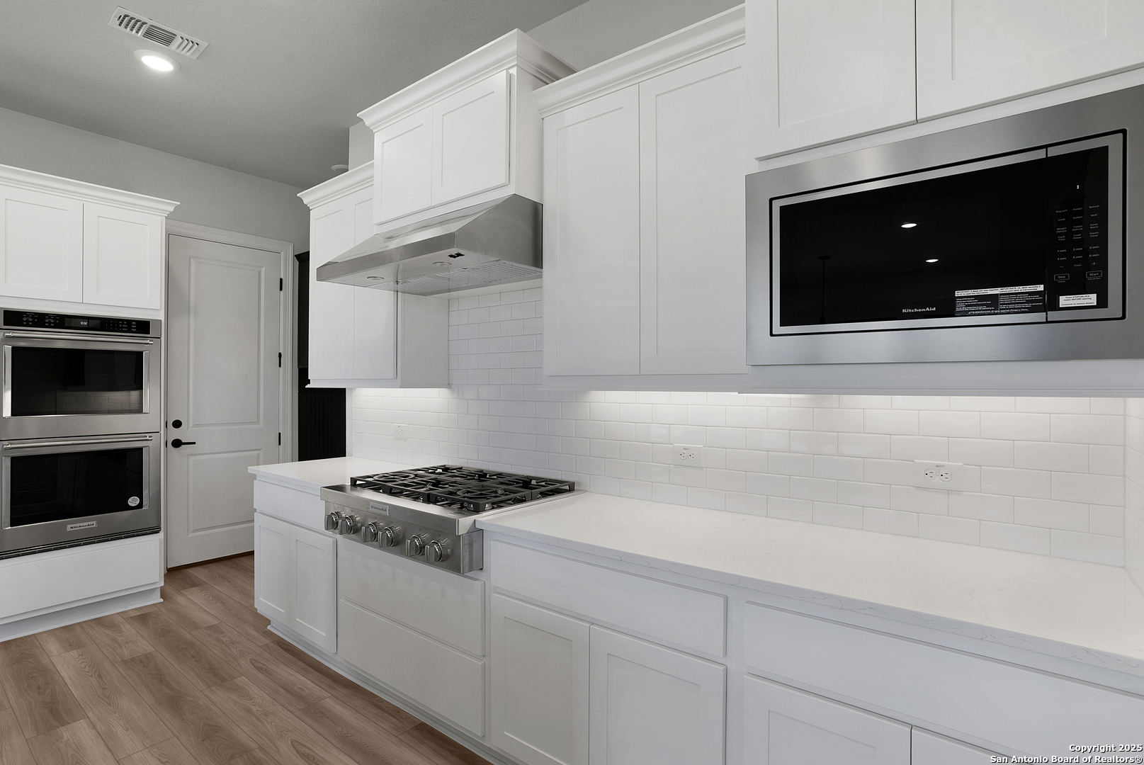 972 Nolte Bend Seguin, TX 78155 - Photo 24 of 65 a kitchen with stainless steel appliances white cabinets and stove