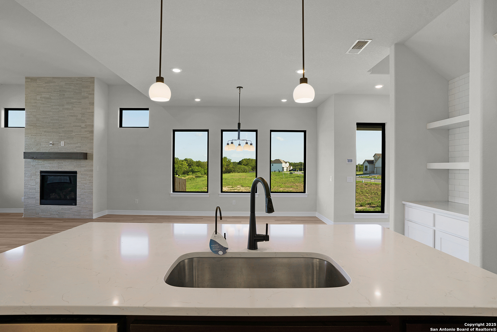 972 Nolte Bend Seguin, TX 78155 - Photo 25 of 65 a kitchen with a sink a large window and stainless steel appliances