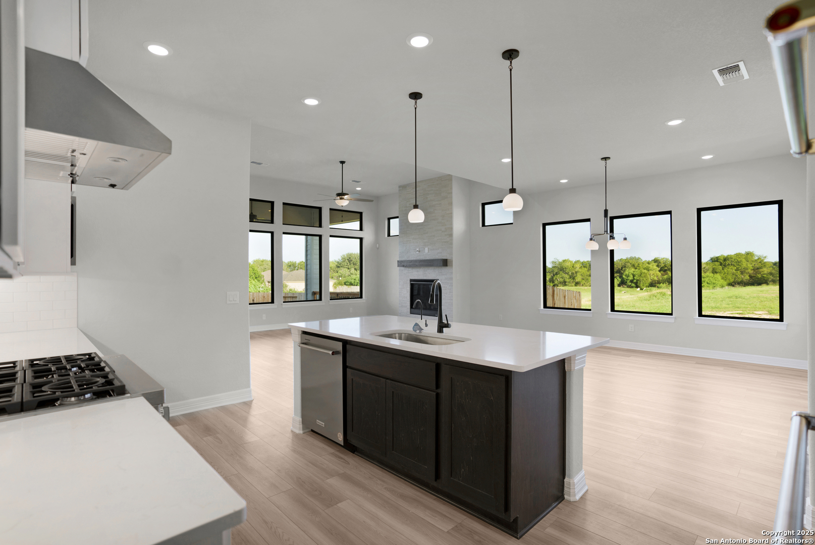 972 Nolte Bend Seguin, TX 78155 - Photo 29 of 65 a kitchen with a sink a counter top space and stainless steel appliances