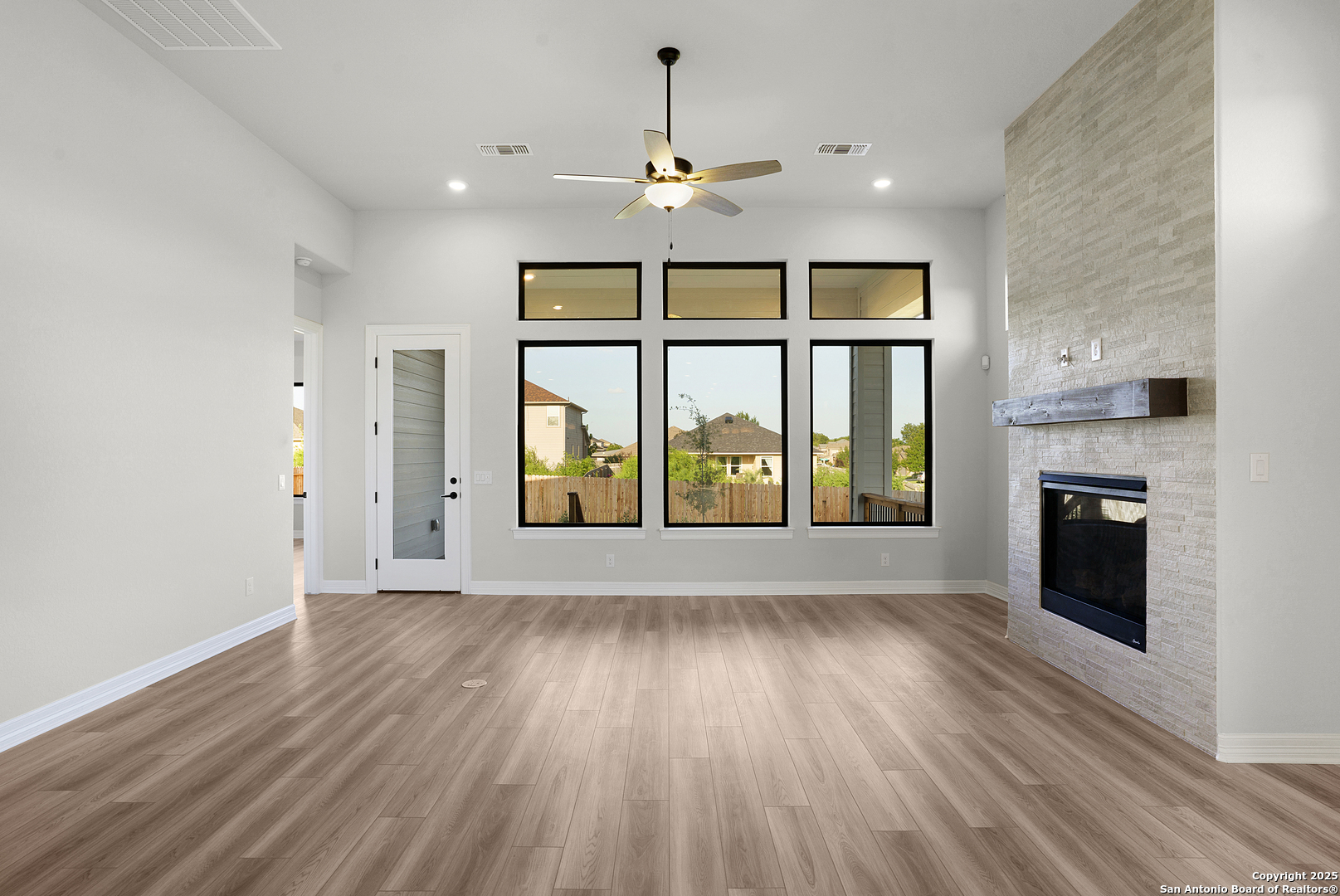 972 Nolte Bend Seguin, TX 78155 - Photo 30 of 65 an empty room with windows and fireplace