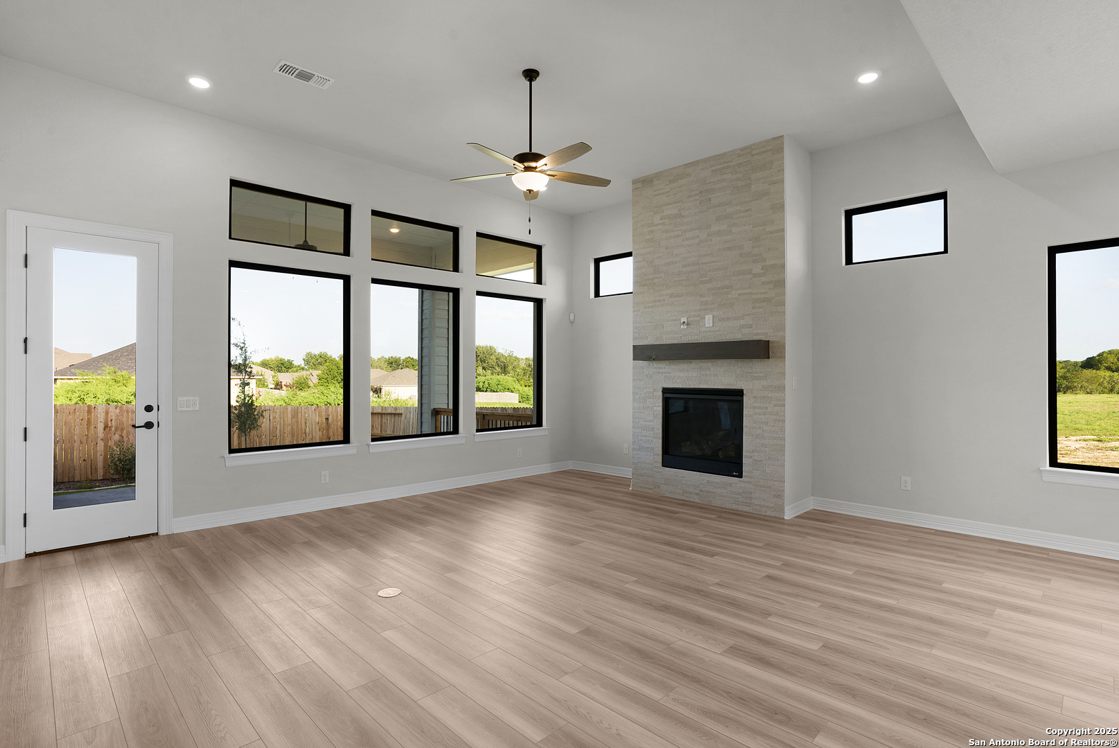 972 Nolte Bend Seguin, TX 78155 - Photo 31 of 65 an empty room with wooden floor chandelier and windows
