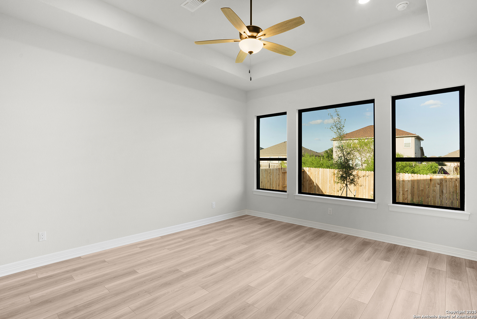 972 Nolte Bend Seguin, TX 78155 - Photo 36 of 65 an empty room with wooden floor and windows