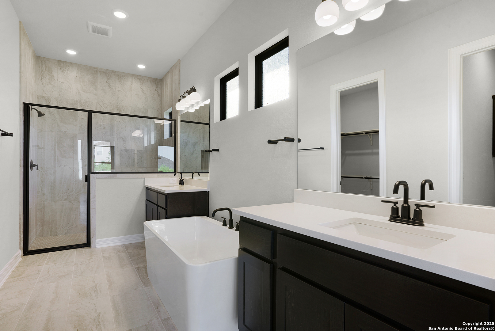 972 Nolte Bend Seguin, TX 78155 - Photo 38 of 65 a bathroom with a double vanity sink a mirror and shower