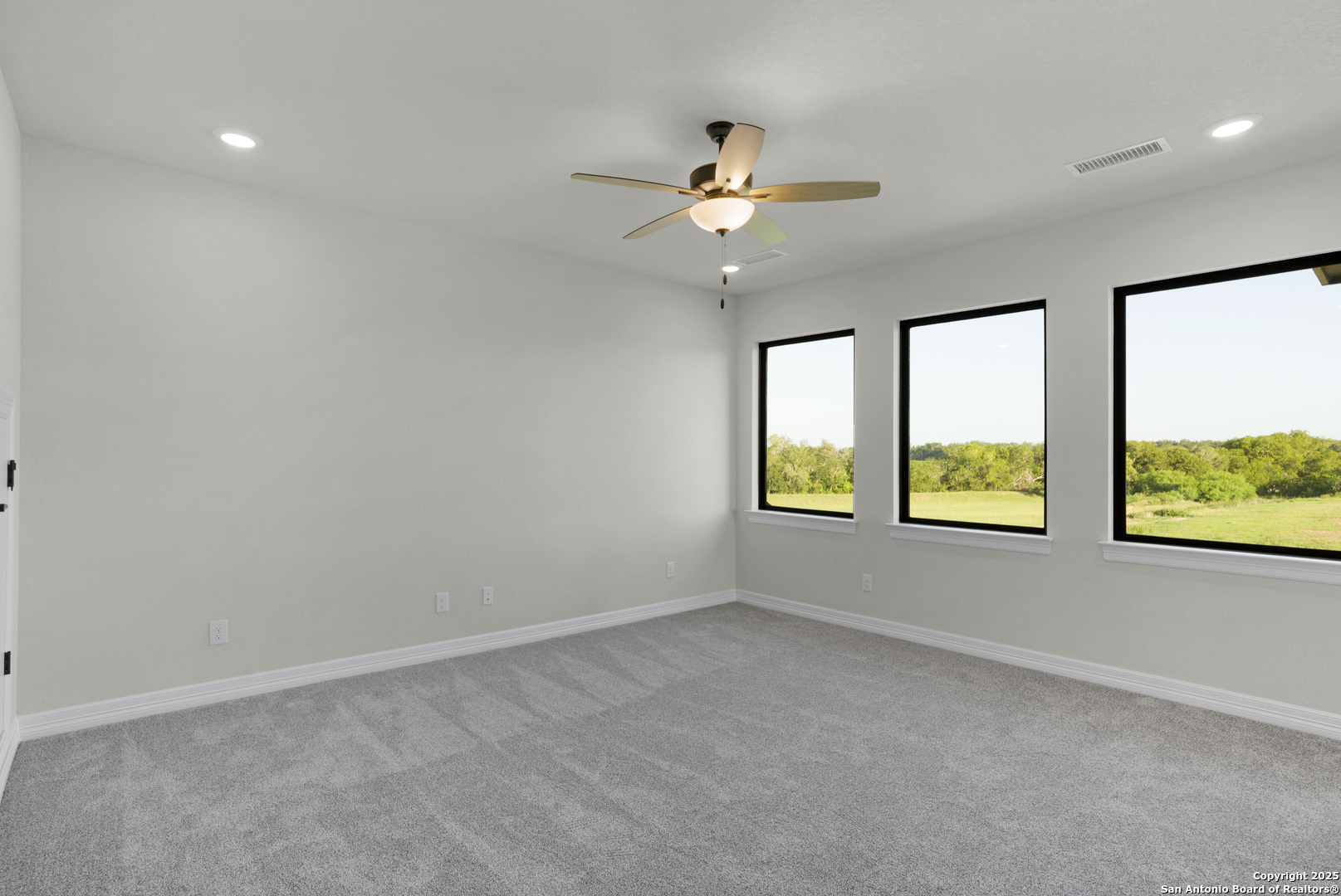 972 Nolte Bend Seguin, TX 78155 - Photo 46 of 65 an empty room with windows and fan