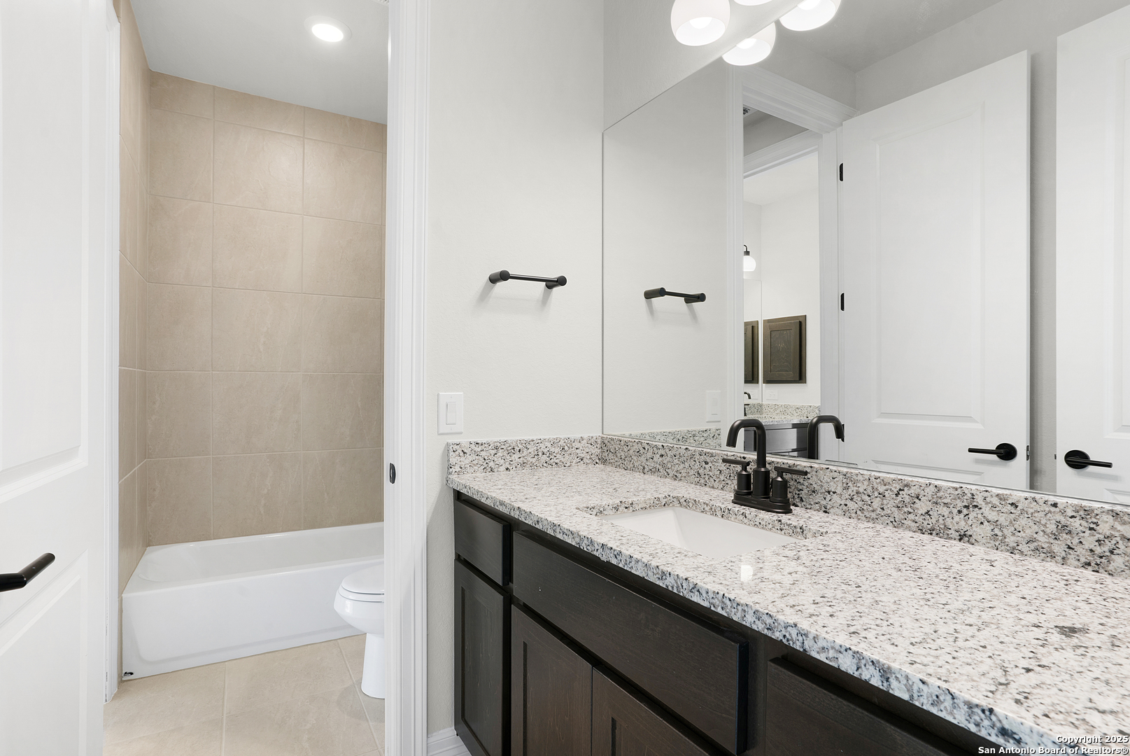 972 Nolte Bend Seguin, TX 78155 - Photo 52 of 65 a bathroom with a granite countertop sink a toilet and bathtub