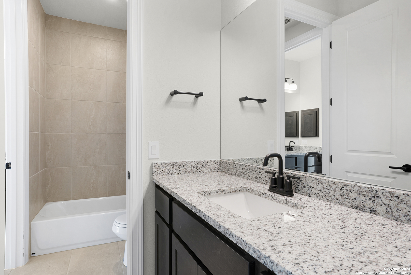 972 Nolte Bend Seguin, TX 78155 - Photo 53 of 65 a bathroom with a granite countertop sink and a mirror