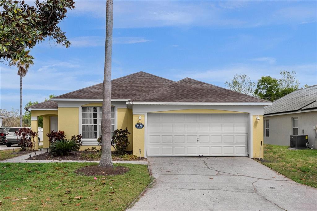 217 Holborn Loop Davenport, FL 33897 - Photo 1 of 32 a front view of a house with garden