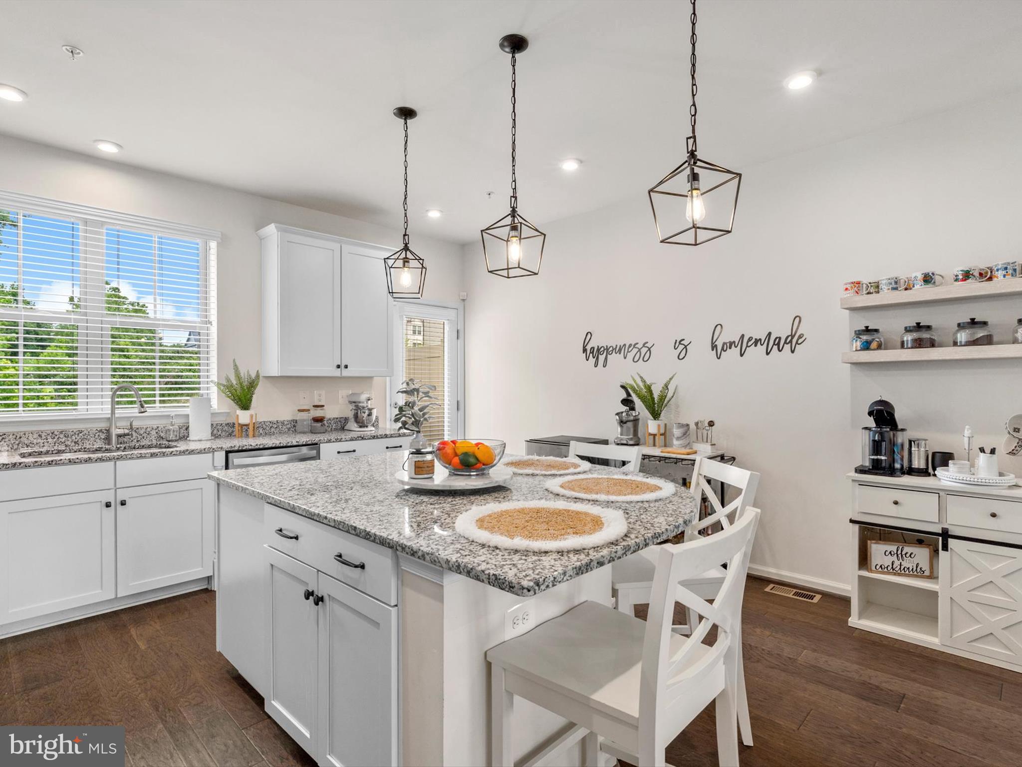 3058 Bretons Ridge Way Hanover, MD 21076 - Photo 15 of 43 a kitchen that has a sink a stove and chairs