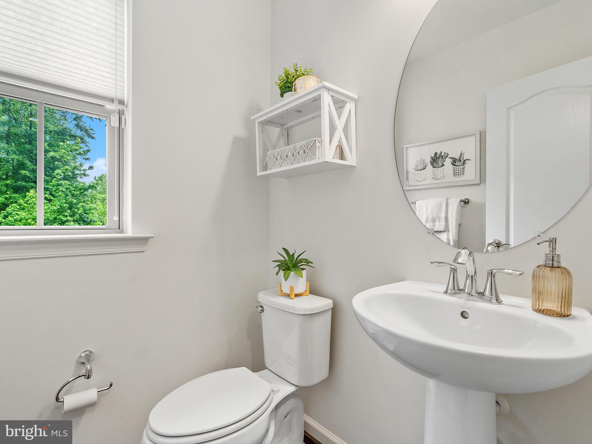 3058 Bretons Ridge Way Hanover, MD 21076 - Photo 18 of 43 a bathroom with a sink a mirror and a toilet