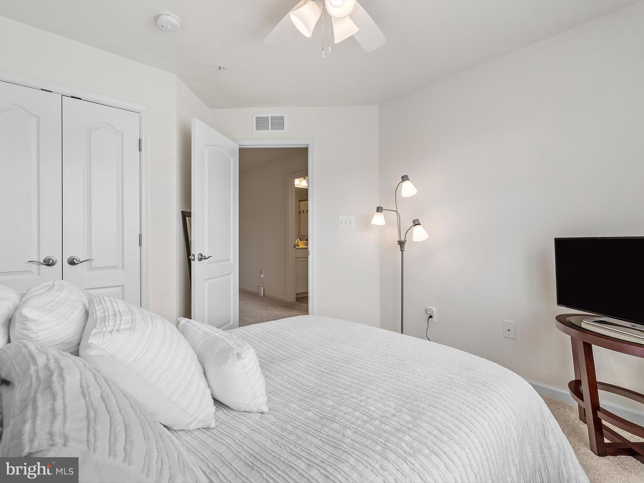 3058 Bretons Ridge Way Hanover, MD 21076 - Photo 22 of 43 a bedroom with a bed and a flat tv screen on dresser