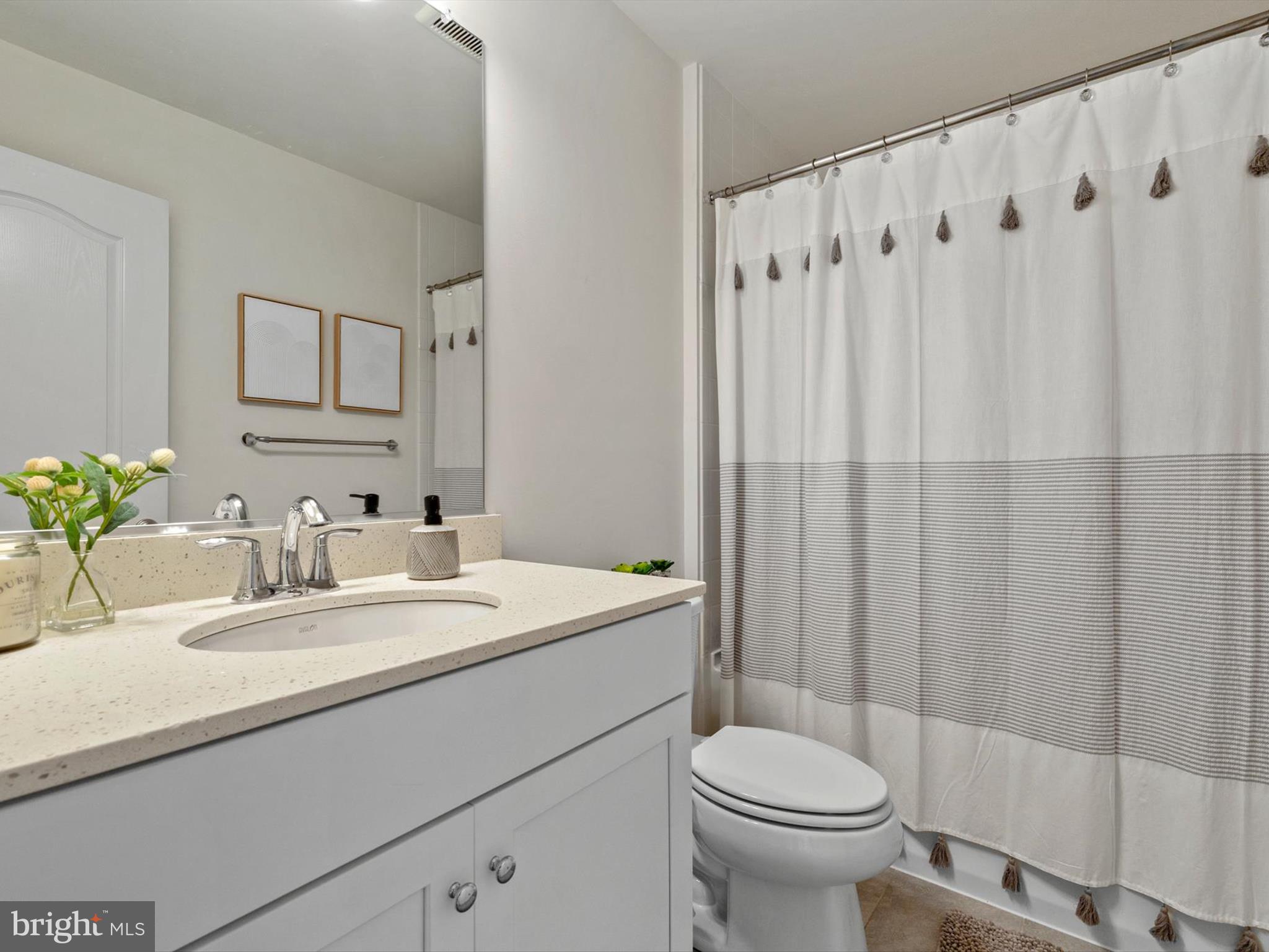 3058 Bretons Ridge Way Hanover, MD 21076 - Photo 23 of 43 a bathroom with a granite countertop sink a toilet and a mirror