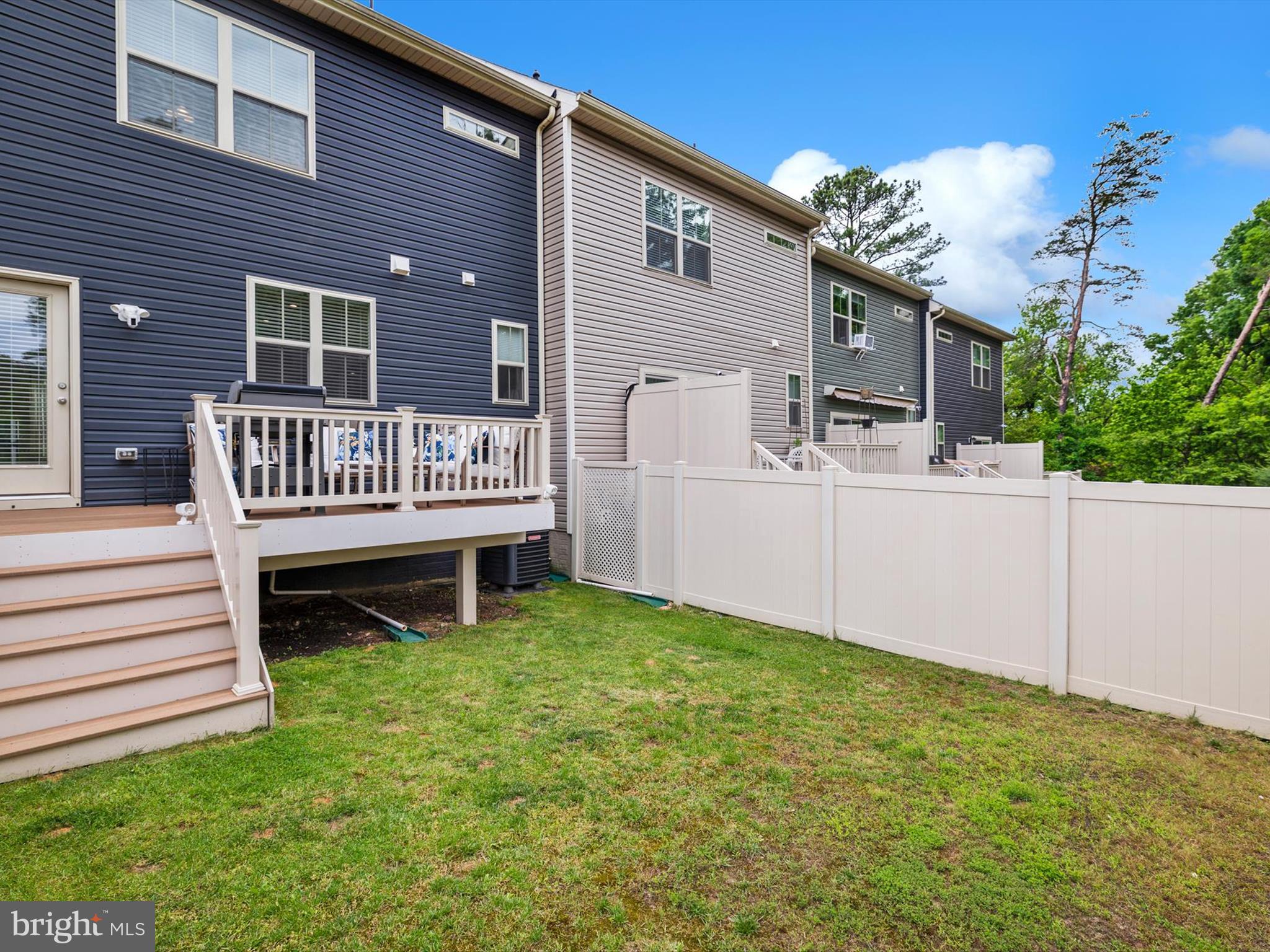 3058 Bretons Ridge Way Hanover, MD 21076 - Photo 38 of 43 a view of a house with a small deck and a yard
