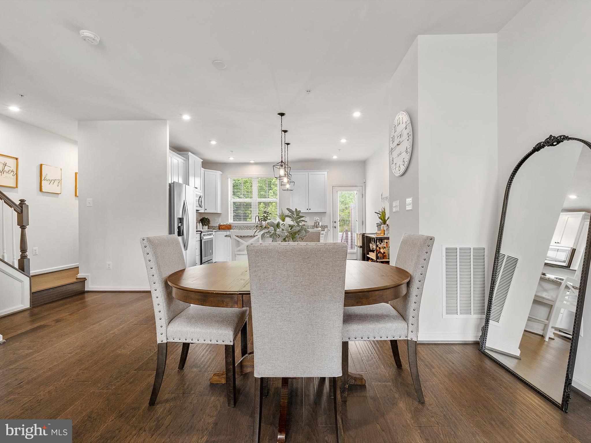 3058 Bretons Ridge Way Hanover, MD 21076 - Photo 10 of 43 a view of a dining room with furniture and wooden floor