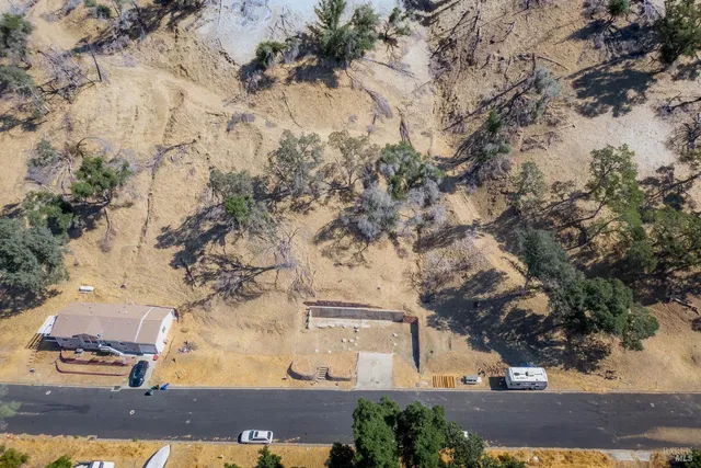 an aerial view of a house with a yard