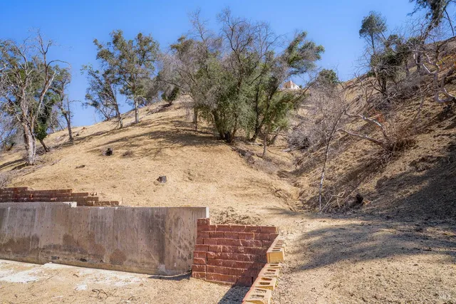 a view of a yard with wooden fence