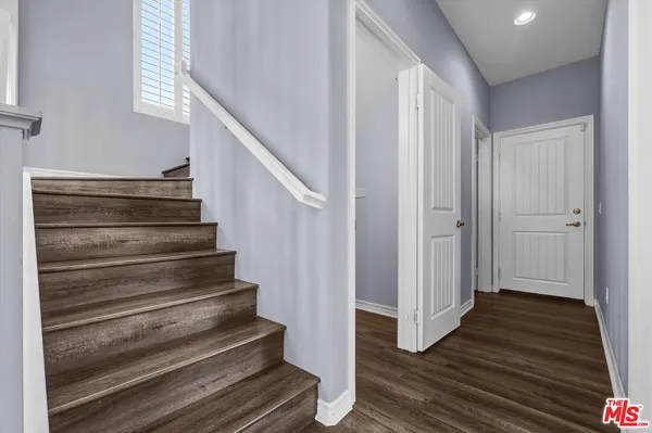 a view of entryway and hall with wooden floor