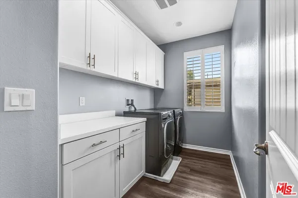 a view of a kitchen with closet and electronic appliances