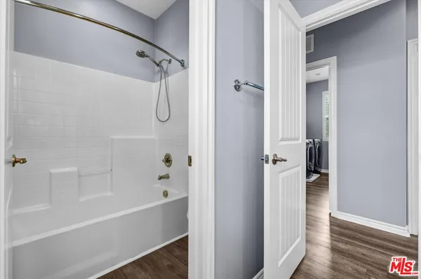 a bathroom with a bathtub and a shower