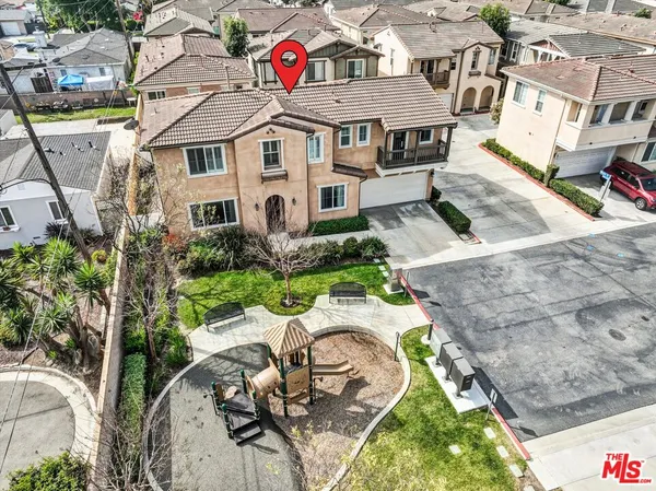 an aerial view of a house with a backyard