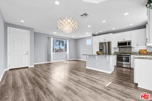 a view of kitchen with cabinets and wooden floor