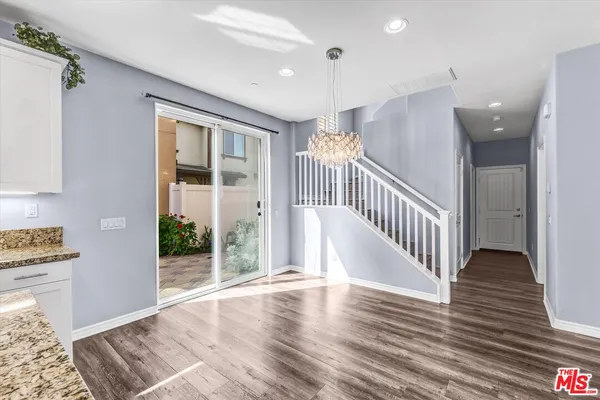 a view of a hallway view with wooden floor and staircase