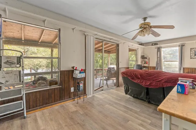 a spacious bedroom with a bed and a large window