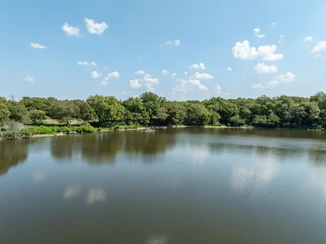 a view of a lake in middle of a house with a lake view