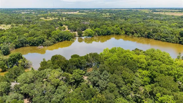 an aerial view of ocean residential house with outdoor space and trees around