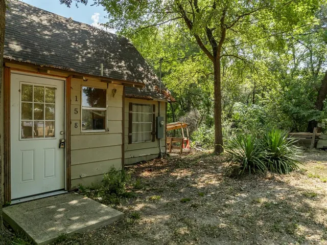 a view of a house with backyard and sitting area