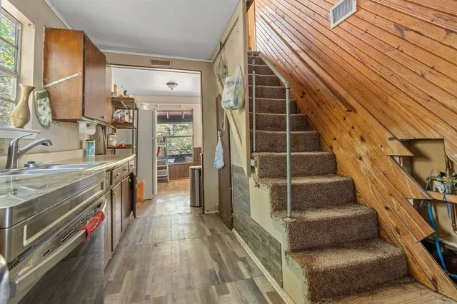 a view of a kitchen with furniture and staircase
