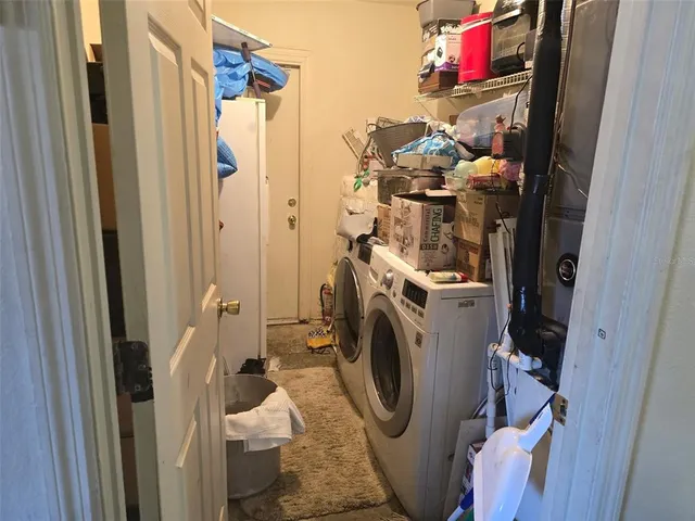 a view of a storage and utility room with washer and dryer
