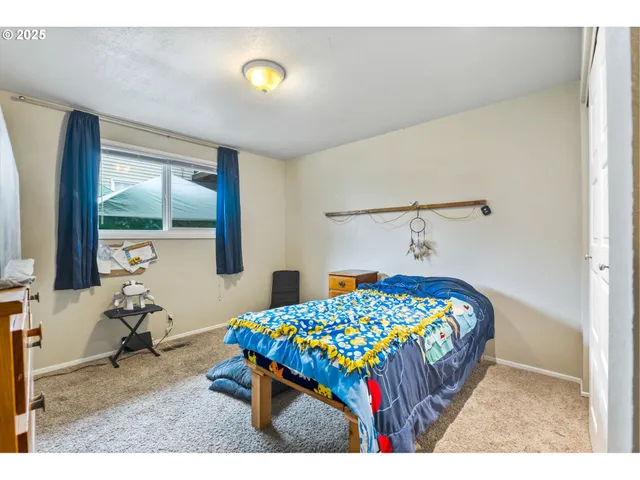 a bedroom with a bed and a table in it