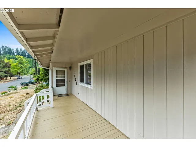 a view of empty room with furniture and a window