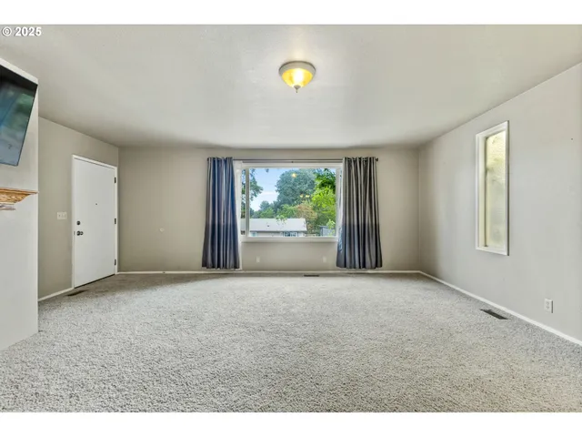 a living room with a fireplace and a flat screen tv