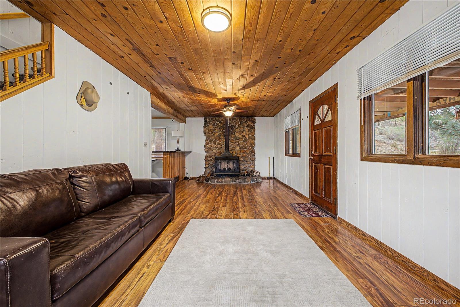 145 Bailey Drive Bailey, CO 80421 - Photo 6 of 31 a living room with furniture and a chandelier