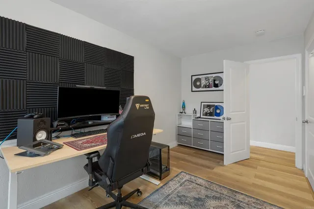 a view of a workspace with furniture and wooden floor