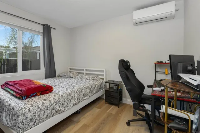 a bedroom with a bed and a desk