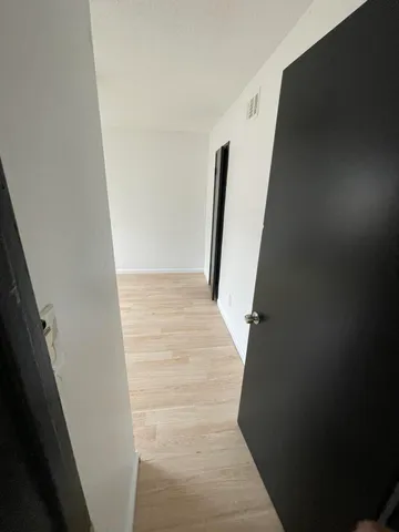 a view of a big room with wooden floor and fan